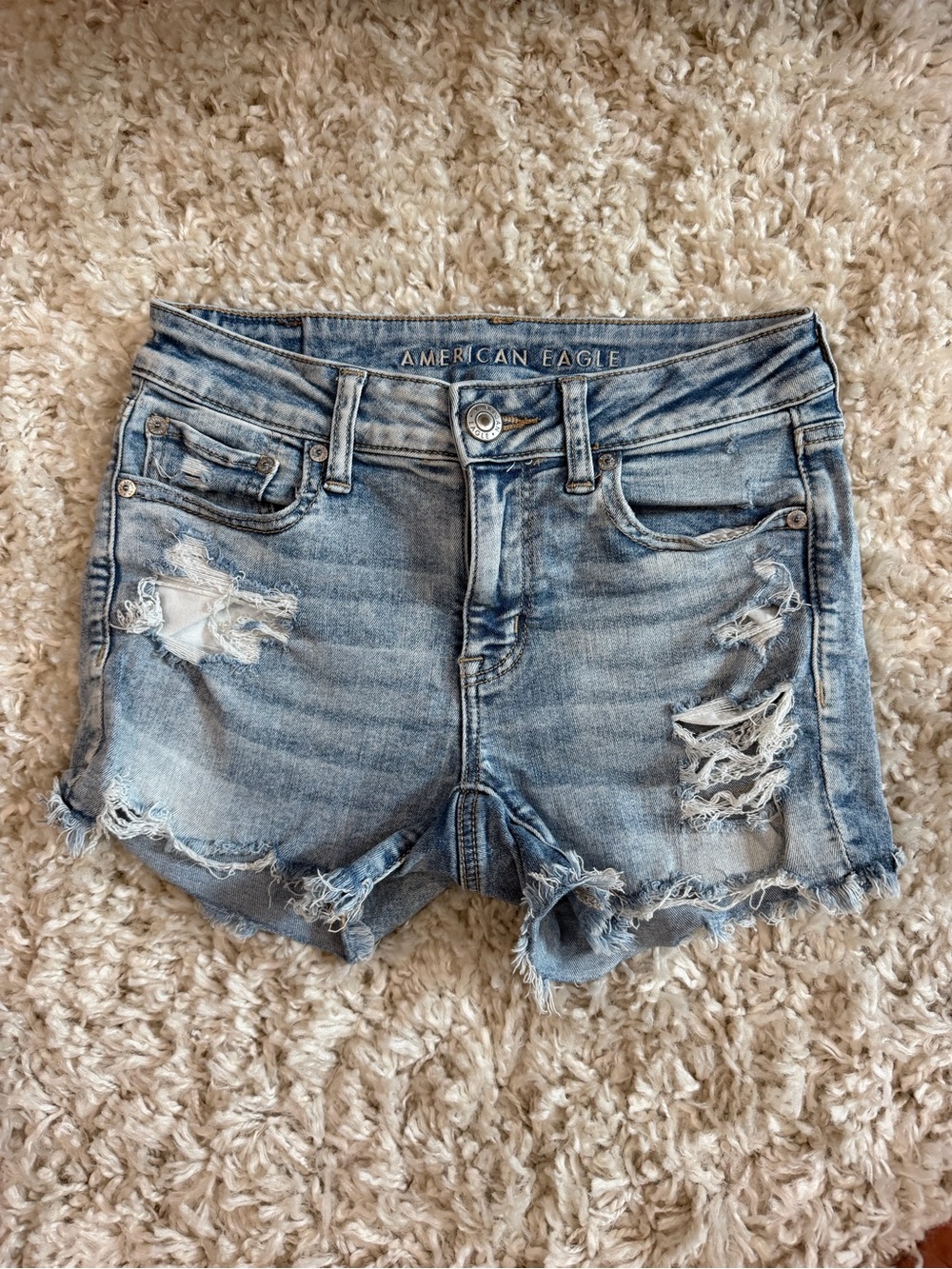 American Eagle Outfitters Women's Light Blue Distressed Denim Shorts. MIDI